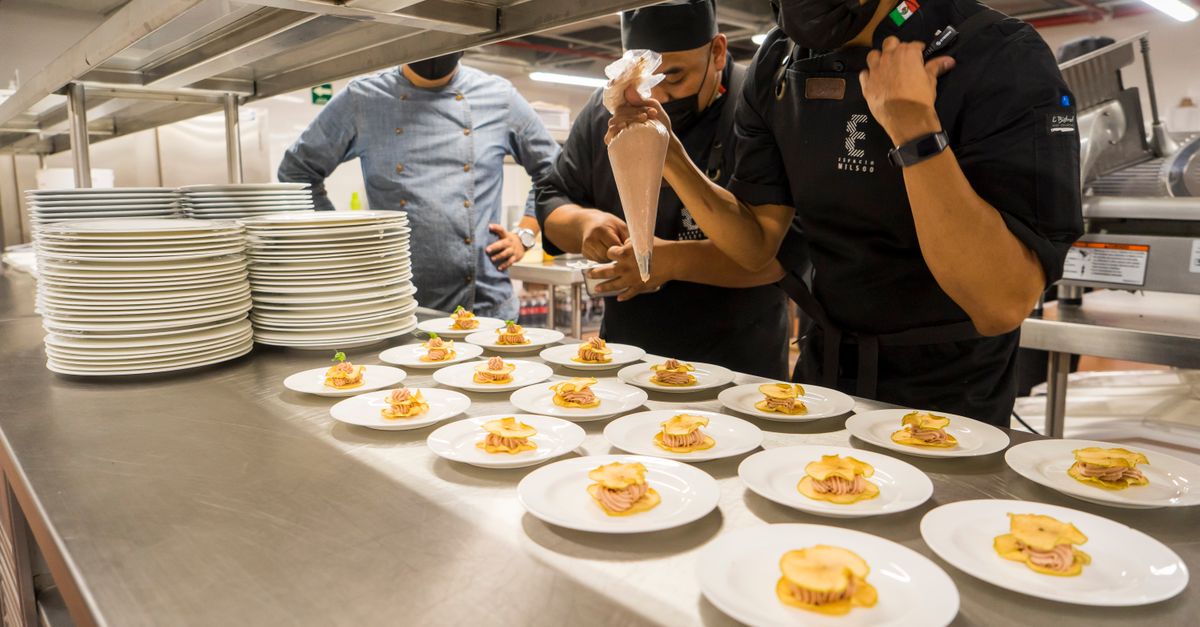 Overhead view of professionally plated food in a restaurant kitchen setting